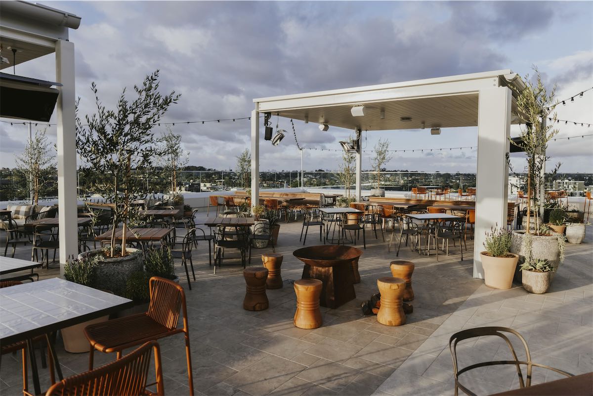 Outdoors space with tables and a sunshade